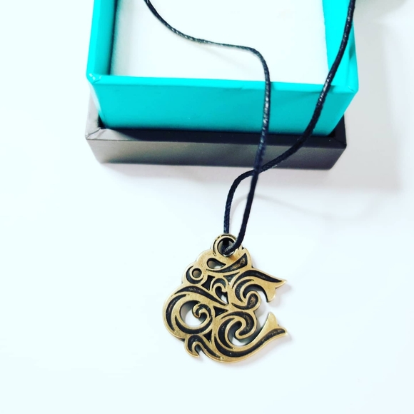 Sacred "Om" symbol pendant with a cord - Picture 1 of 3